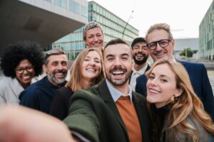Big group of business people smiling taking a selfie portrait toguether. Crowd of business people
