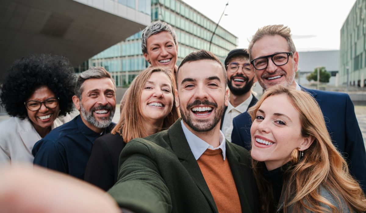 Big group of business people smiling taking a selfie portrait toguether. Crowd of business people